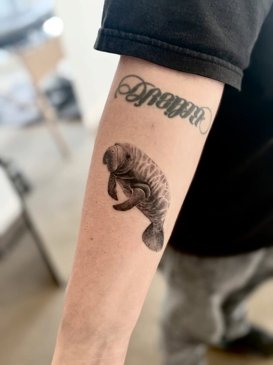 Elegant manatee tattoo showcasing unique artistry Tattoo on skin