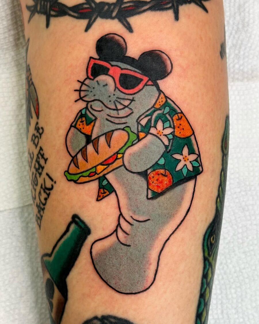 Playful manatee tattoo in Hawaiian shirt Tattoo on skin