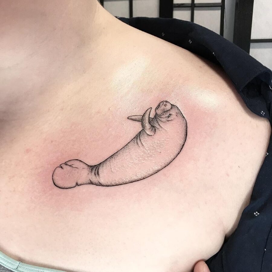 Unique manatee tattoo design on shoulder area Tattoo on skin