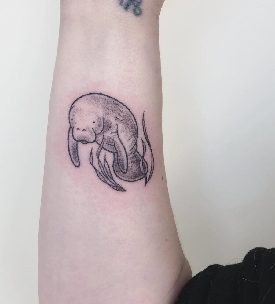 Uniquely styled manatee tattoo in black ink Tattoo on skin