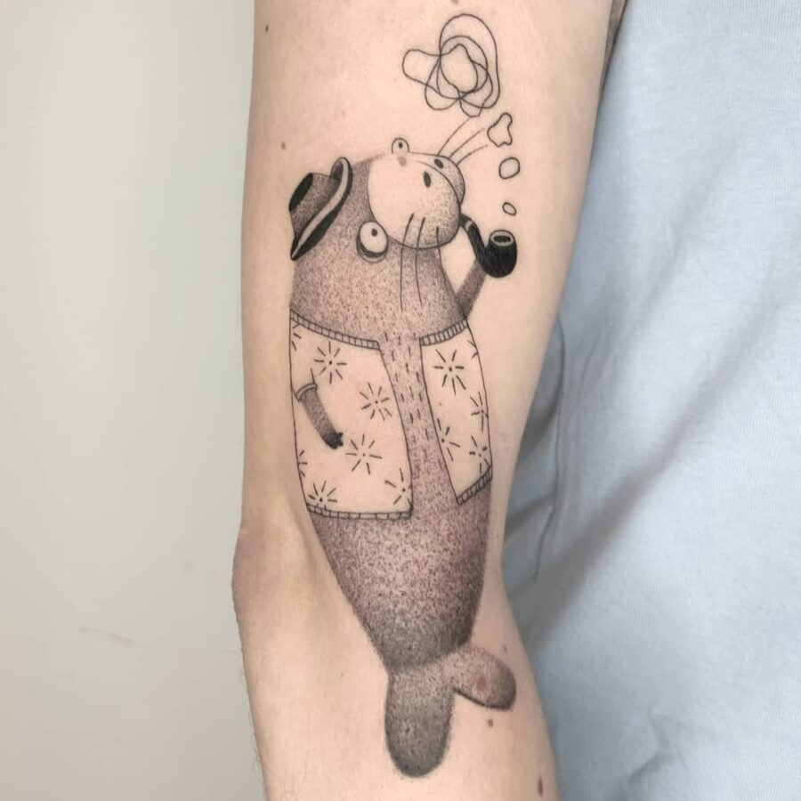 Whimsical manatee enjoying a peaceful smoke Tattoo on skin