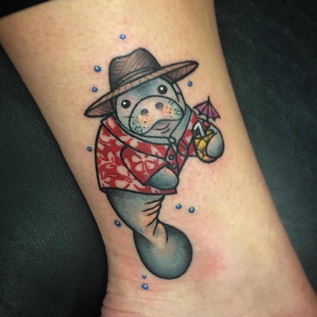 Whimsical manatee in vibrant beach attire Tattoo on skin