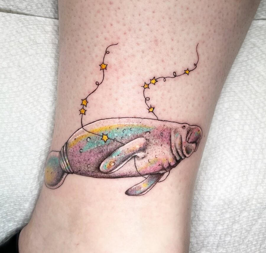 Whimsical manatee tattoo with magical starry vibe Tattoo on skin