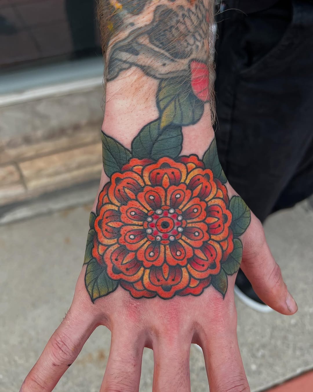 Bold marigold tattoo on hand showcases beauty Tattoo on skin