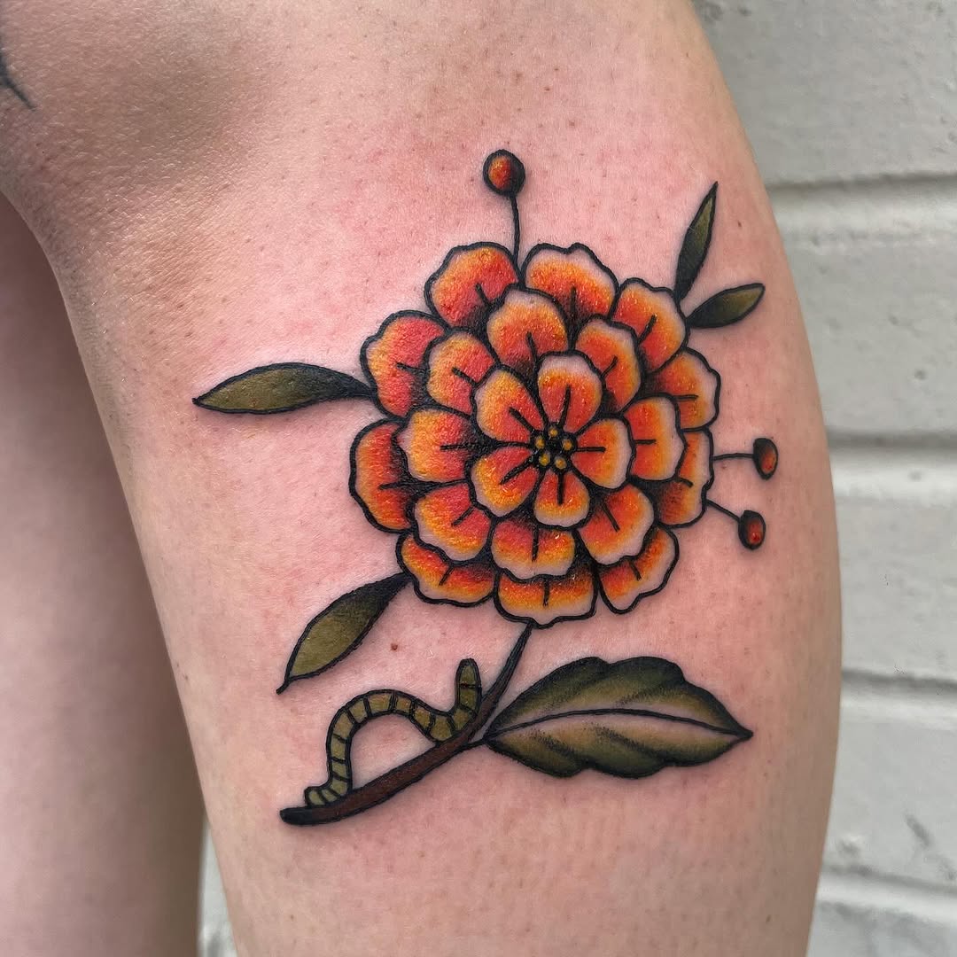 Bold marigold tattoo showcasing vibrant colors Tattoo on skin