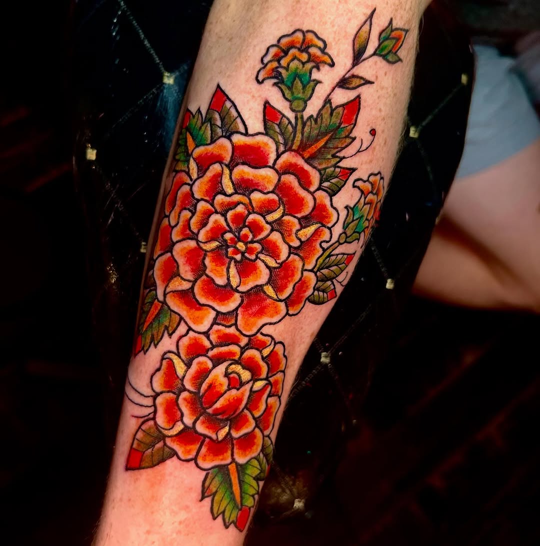 Bold marigold tattoo with vibrant floral elements Tattoo on skin