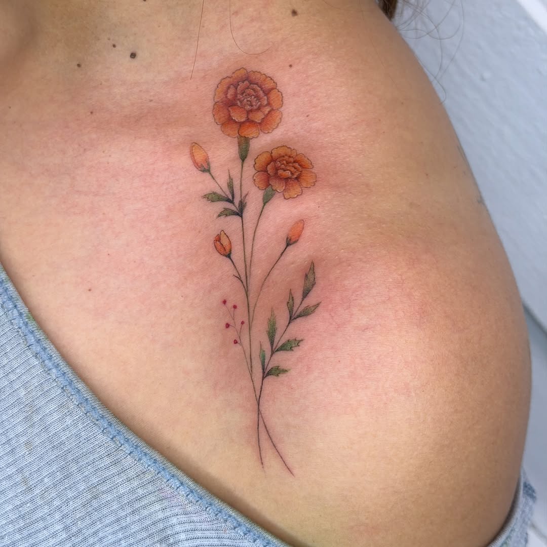 Elegant marigold tattoo exuding vibrant floral beauty Tattoo on skin
