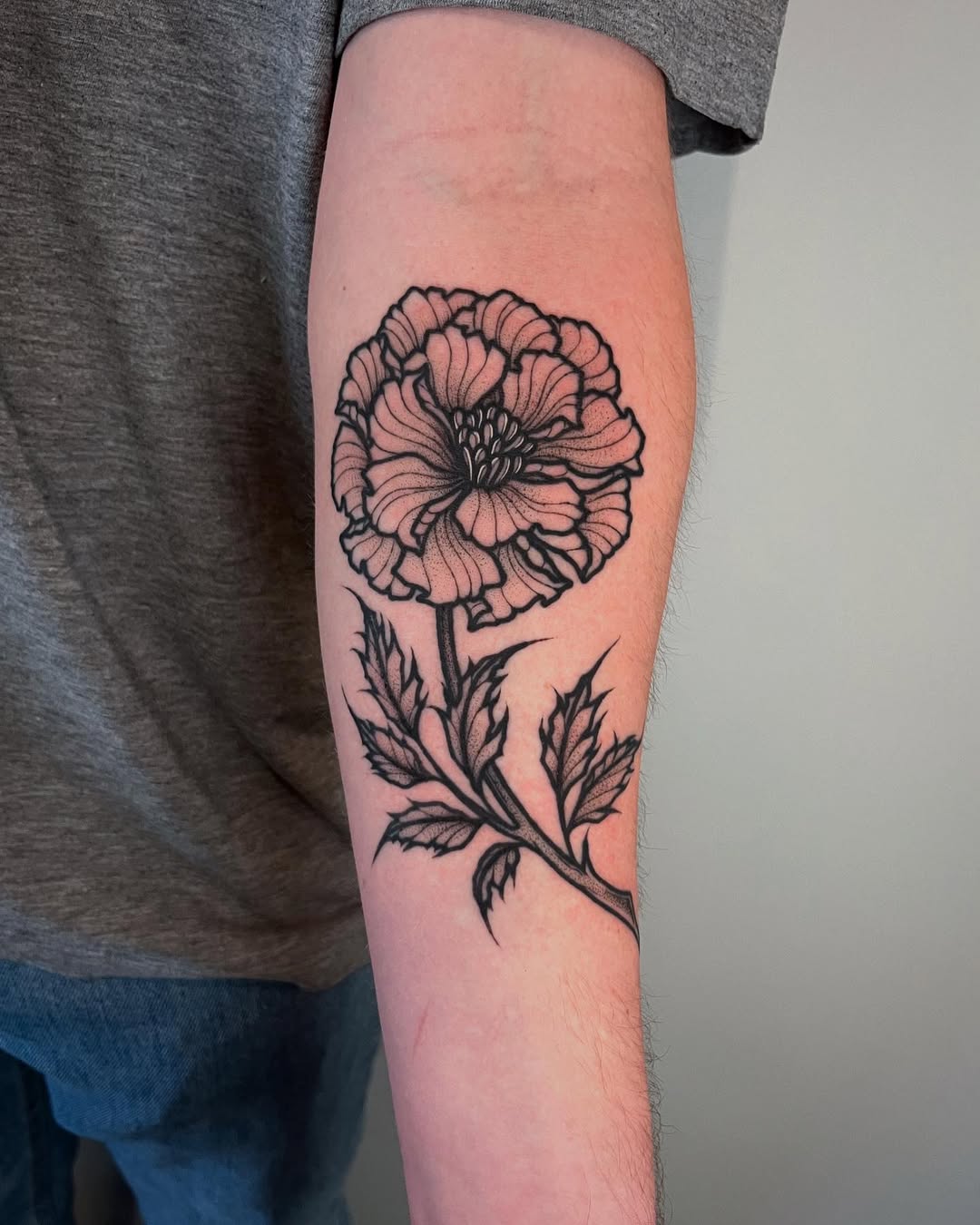 Elegant Marigold Tattoo in Black Ink Tattoo on skin
