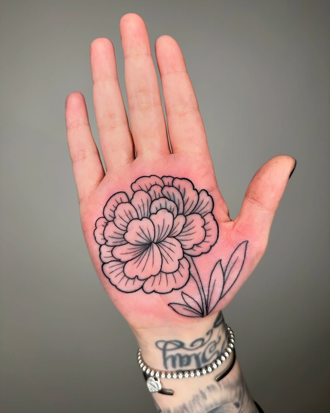 Elegant marigold tattoo on a palm design Tattoo on skin