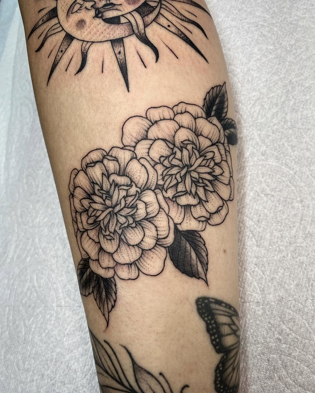 Elegant marigold tattoo with intricate detailing Tattoo on skin
