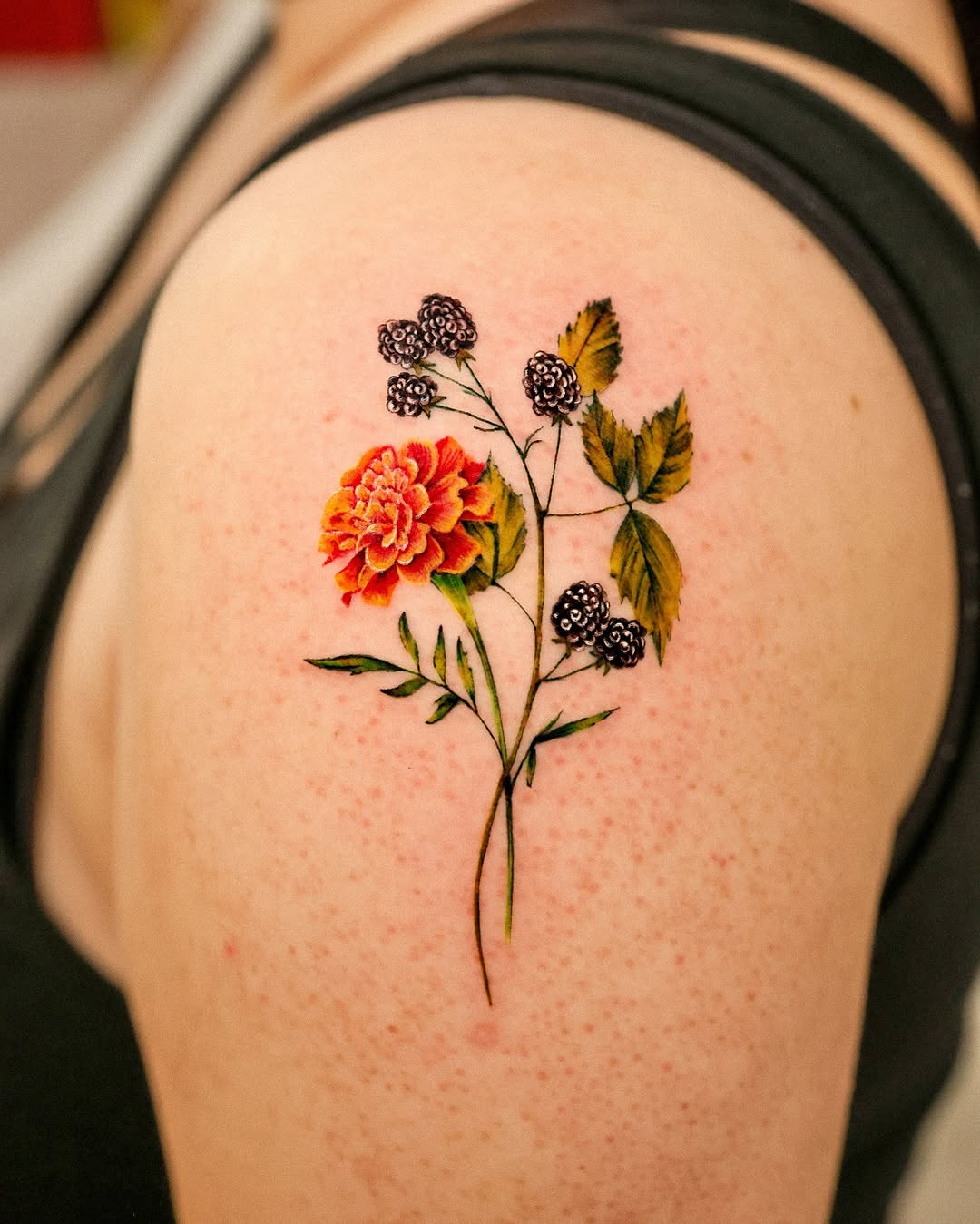 Radiant marigold tattoo showcasing vibrant colors Tattoo on skin