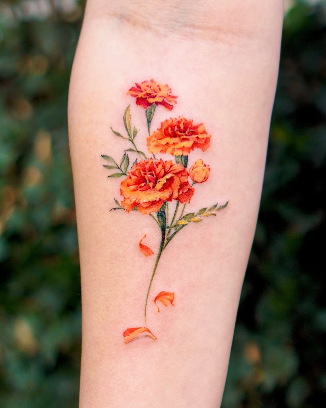 Stunning Marigold Tattoo with Lush Orange Blooms Tattoo on skin