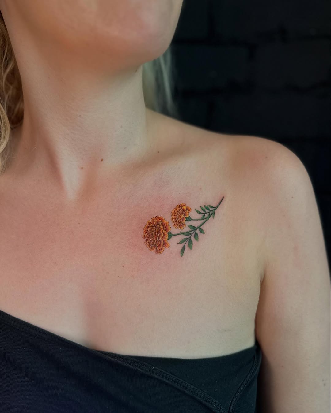 Vibrant marigold tattoo on shoulder area Tattoo on skin