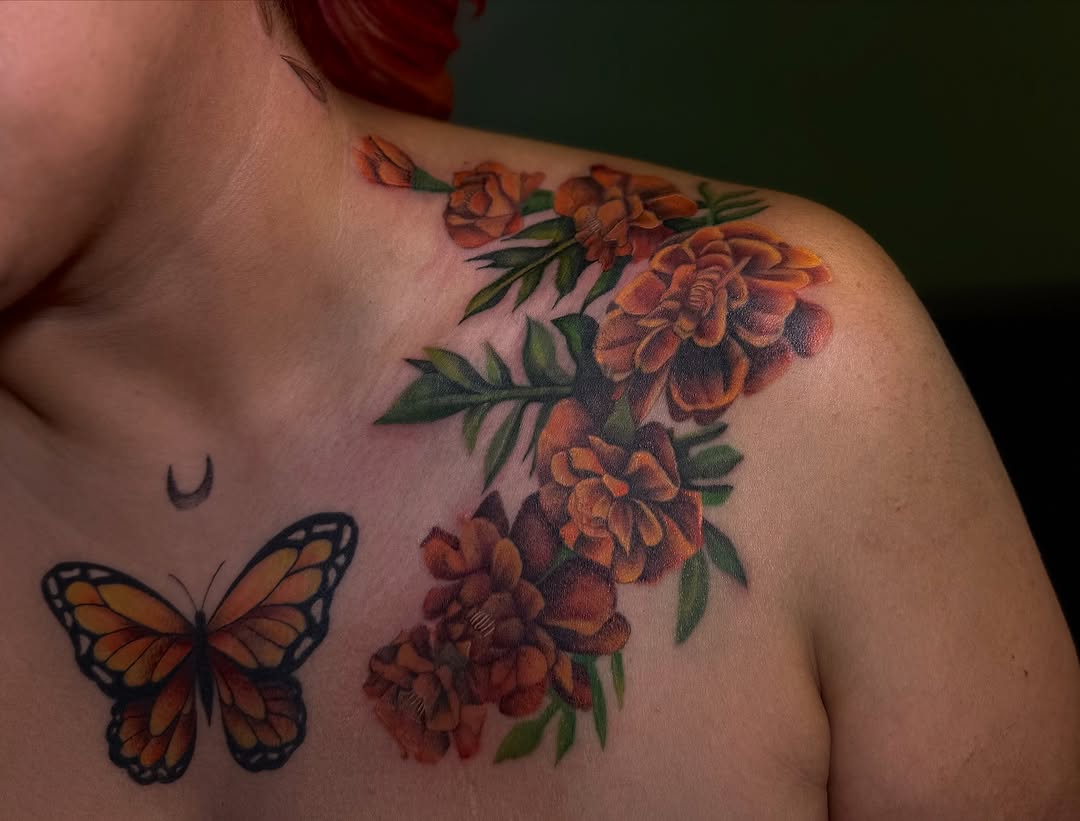 Vibrant marigold tattoo with butterfly detail Tattoo on skin