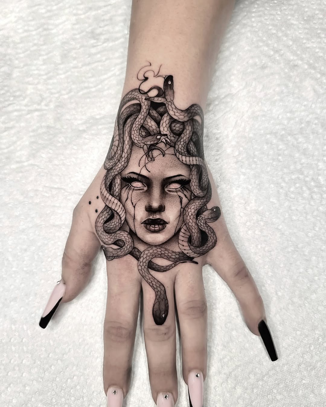 Intricate Medusa Hand Tattoo with Snakes Tattoo on skin