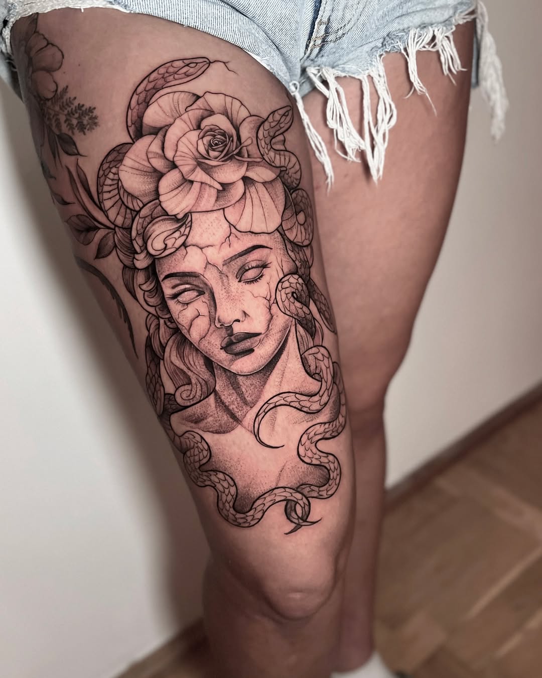 Intricate Medusa Tattoo with Floral Elements Tattoo on skin