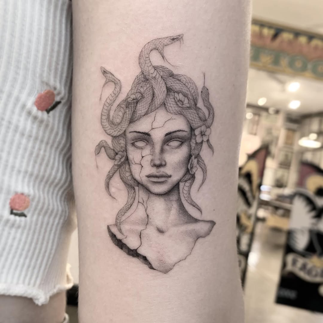 Intricate Medusa Tattoo with Snakes and Flowers Tattoo on skin