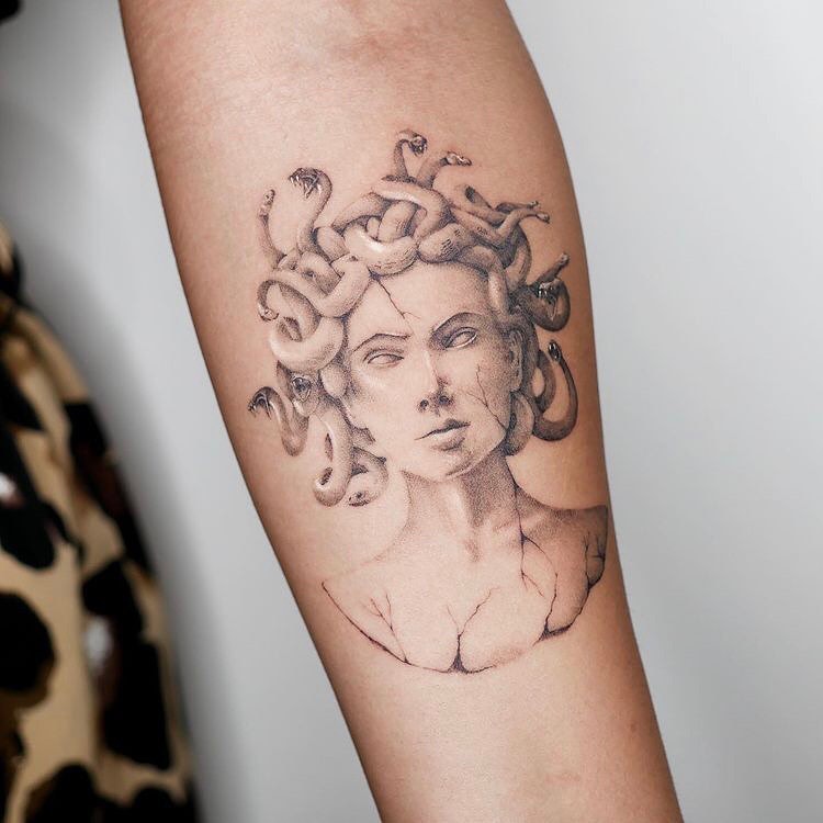 Intricate tattoos featuring classic Medusa imagery. Tattoo on skin
