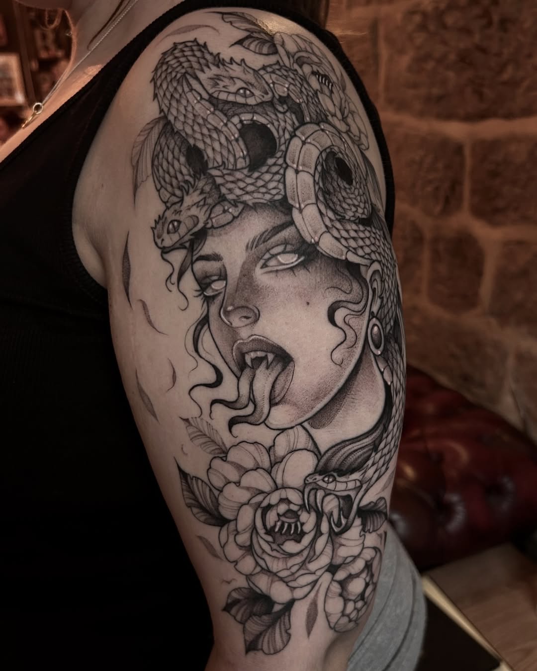 Striking Medusa Design with Serpents and Flowers Tattoo on skin