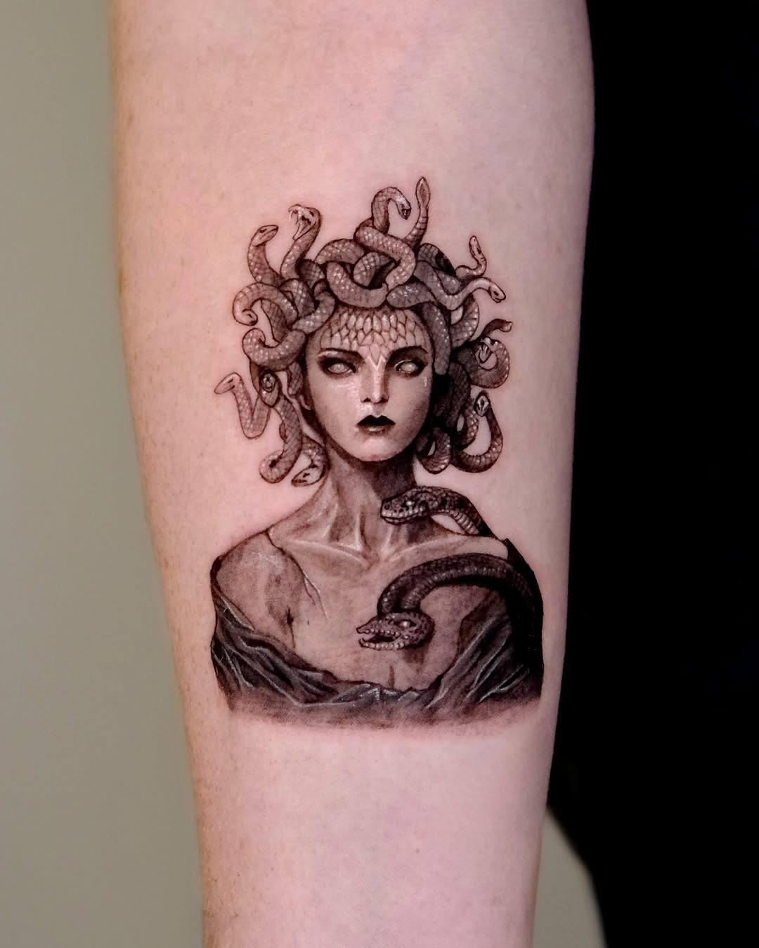 Striking Medusa Tattoo with Serpentine Detail Tattoo on skin