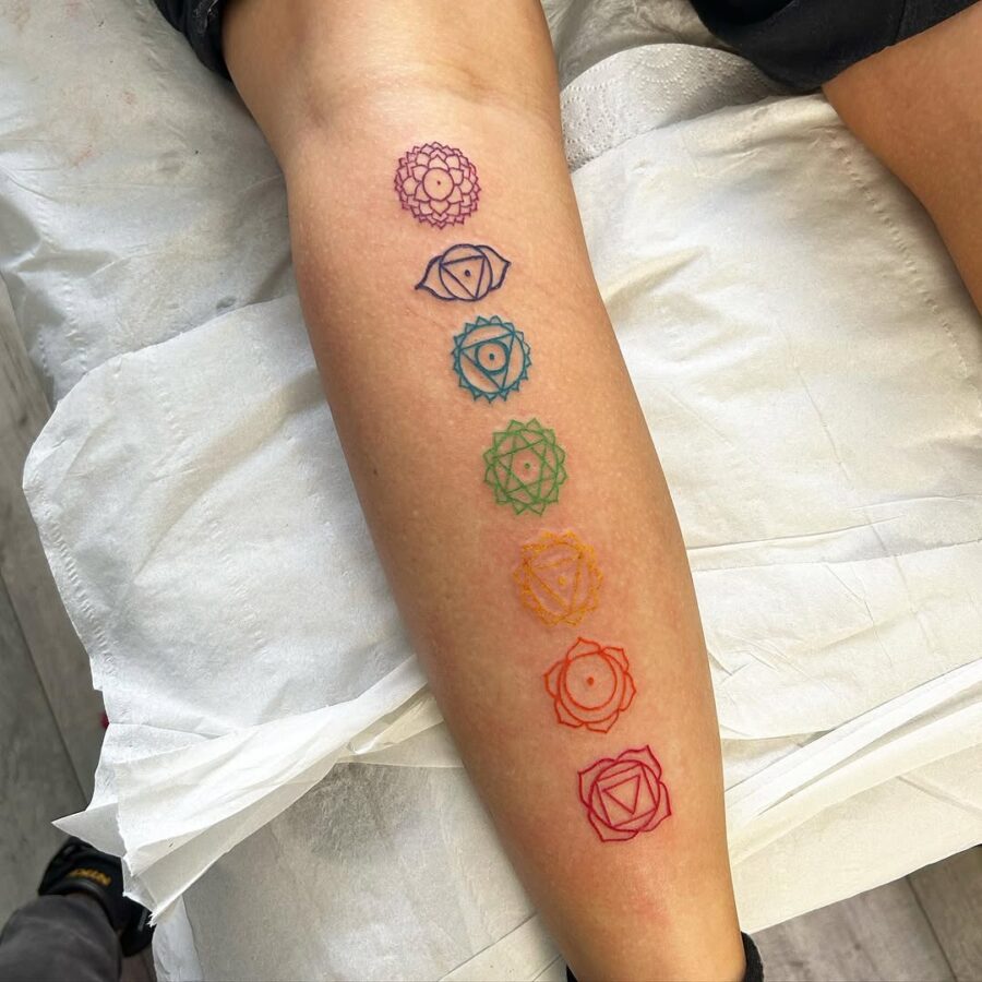 Colorful chakra tattoos symbolize balance and wellness. Tattoo on skin