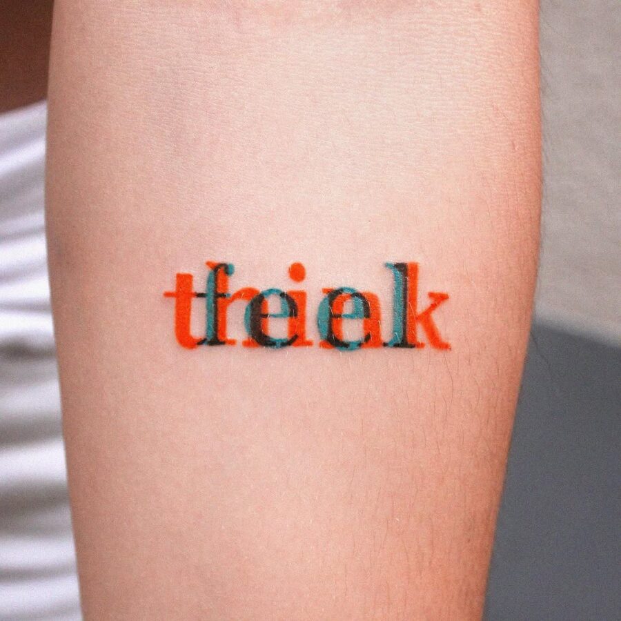 Playful lettering embodies mindful creativity. Tattoo on skin