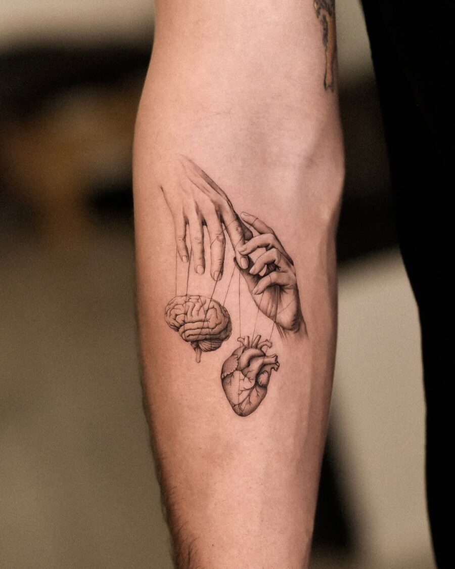 Symbolic hands connecting mind and heart Tattoo on skin