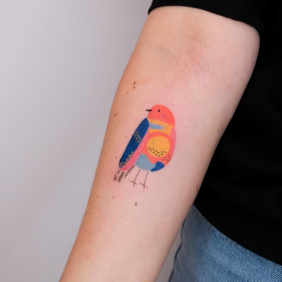 Vibrant bird tattoo promoting mindfulness and peace Tattoo on skin