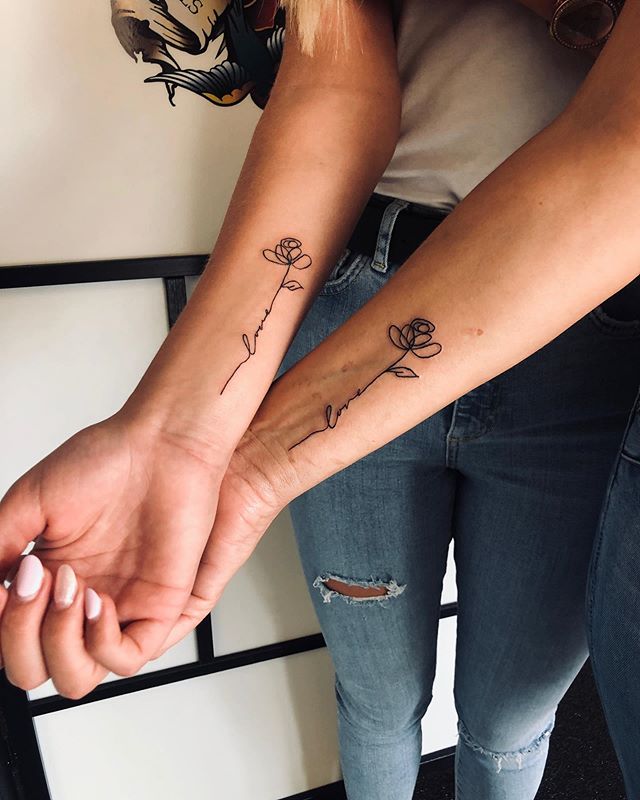 Minimalist “Love”-stemmed Rose Tattoo Tattoo on skin