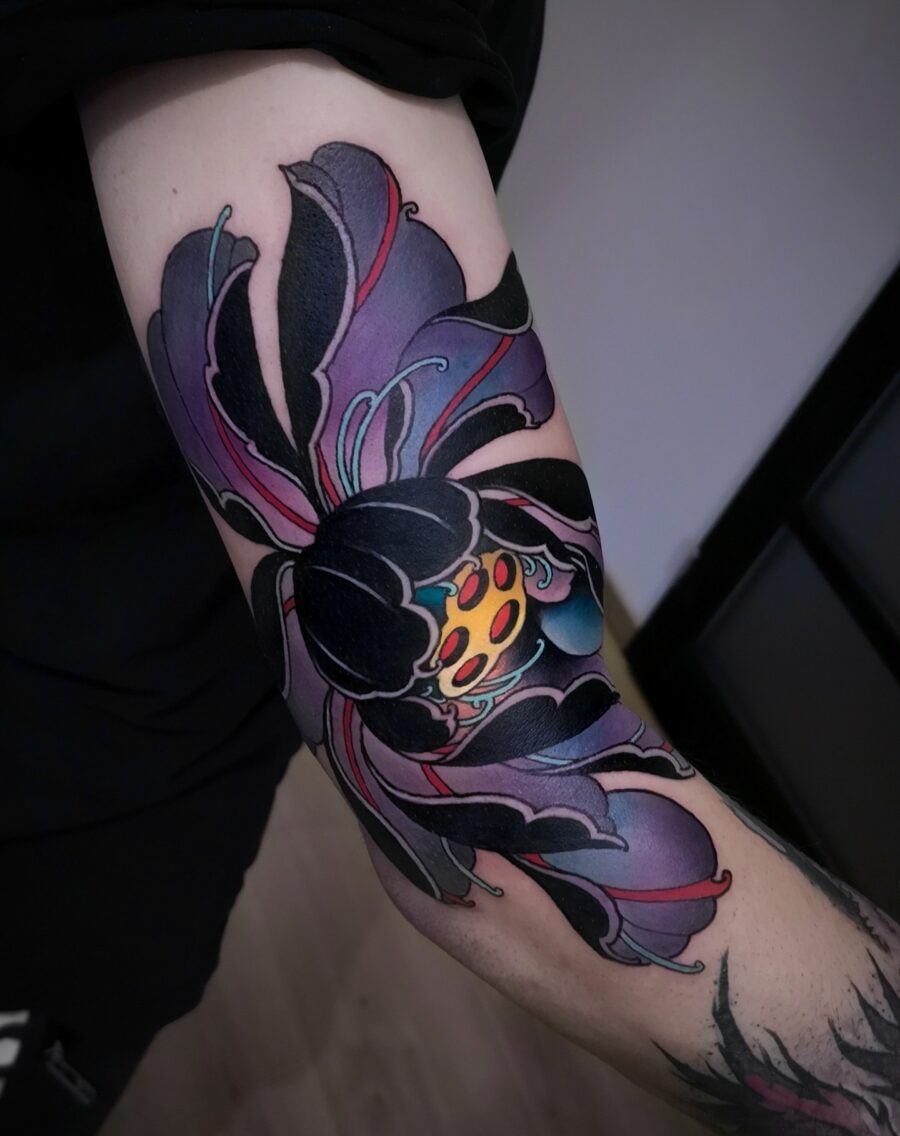 Vibrant neo-traditional flower tattoo with bold colors Tattoo on skin