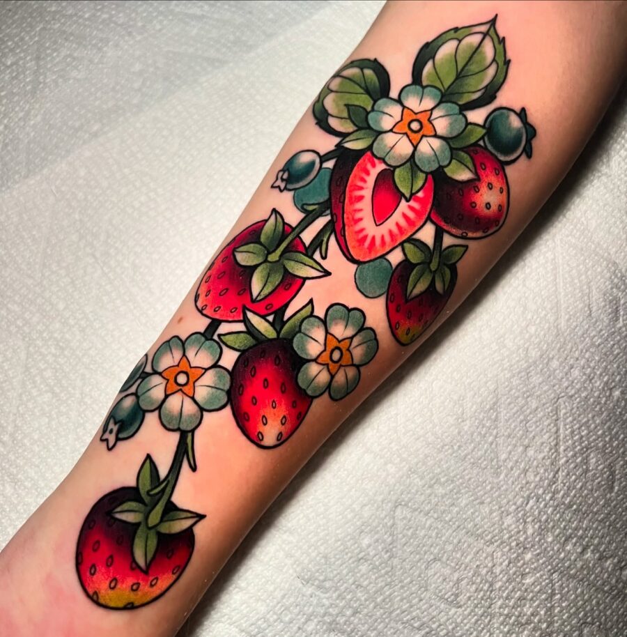 Vibrant neo traditional strawberry and flower design Tattoo on skin