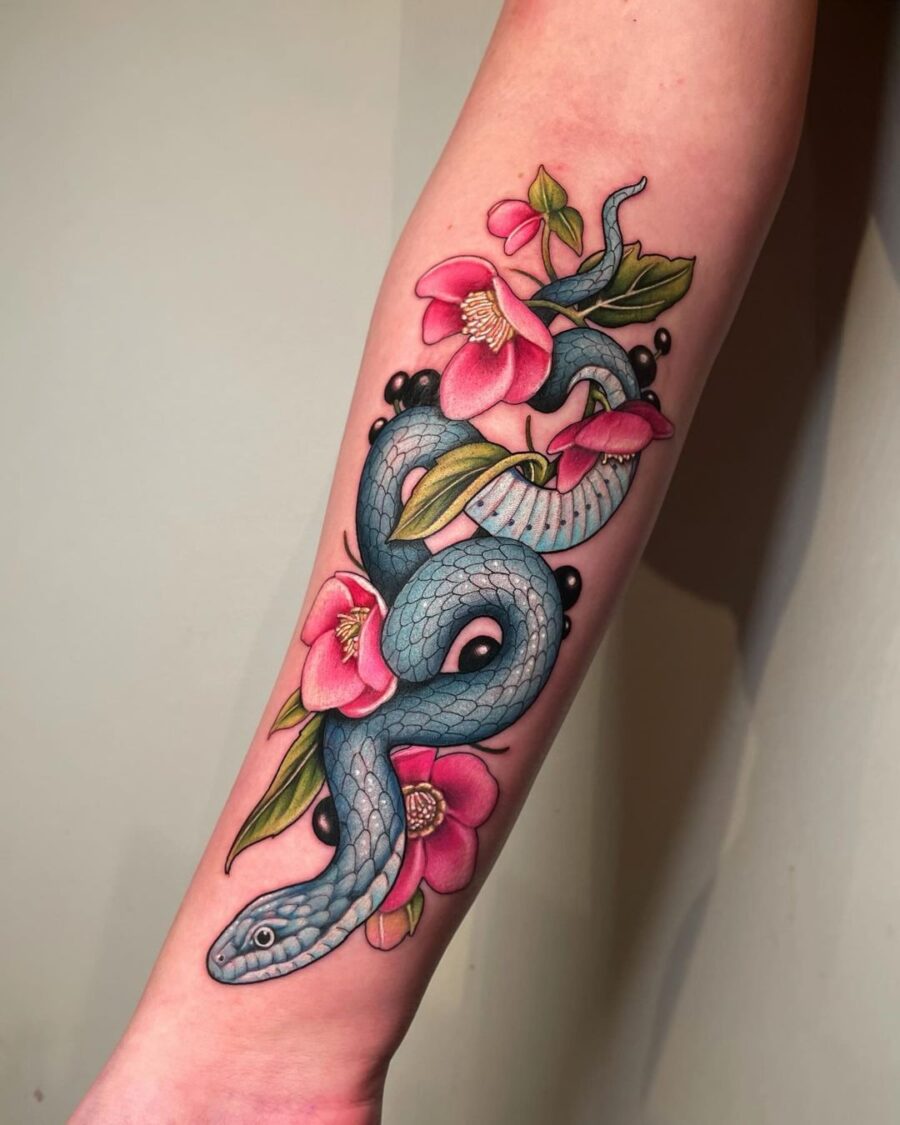 Vibrant snake entwined with blooming flowers Tattoo on skin