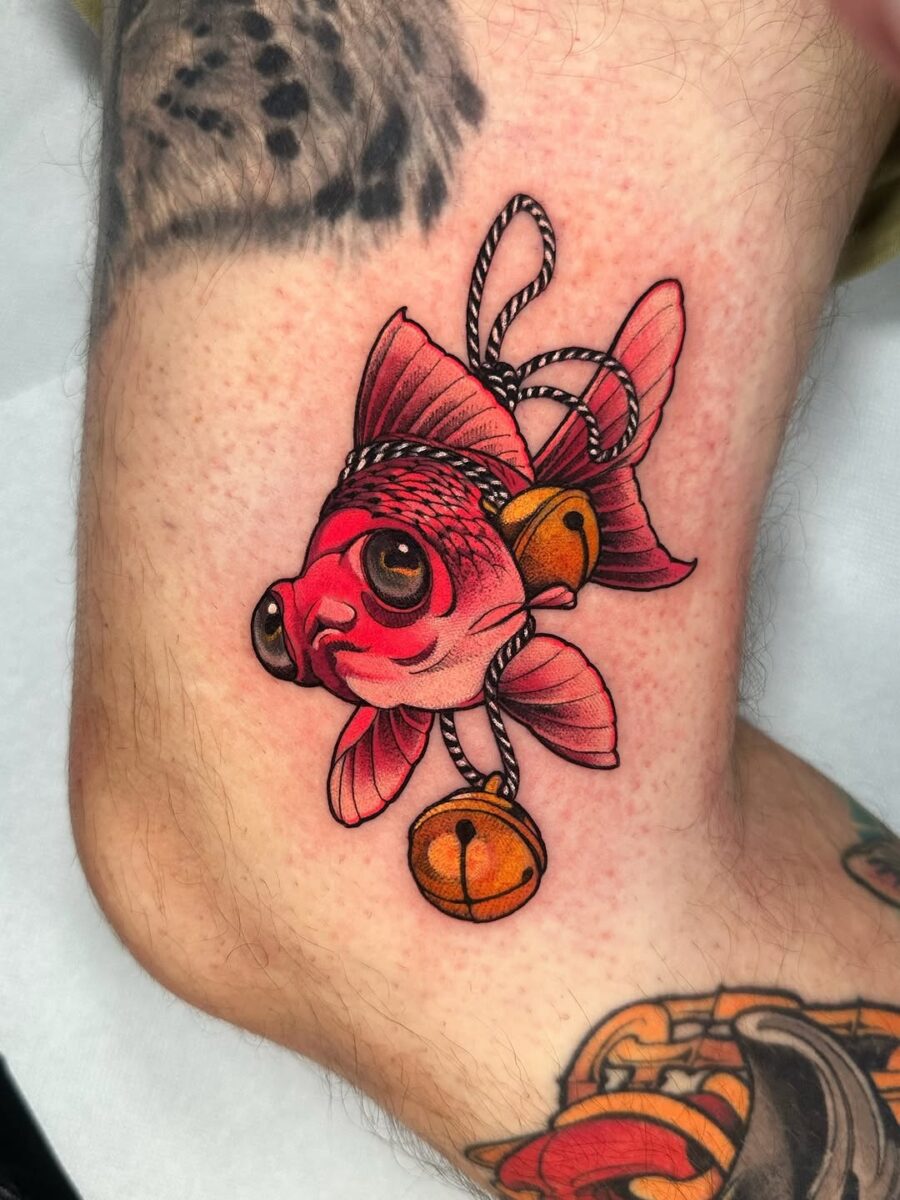 Colorful goldfish tattoo with a playful vibe Tattoo on skin