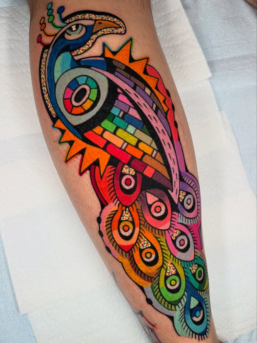 Colorful Peacock Tattoo with Bold Geometric Style Tattoo on skin