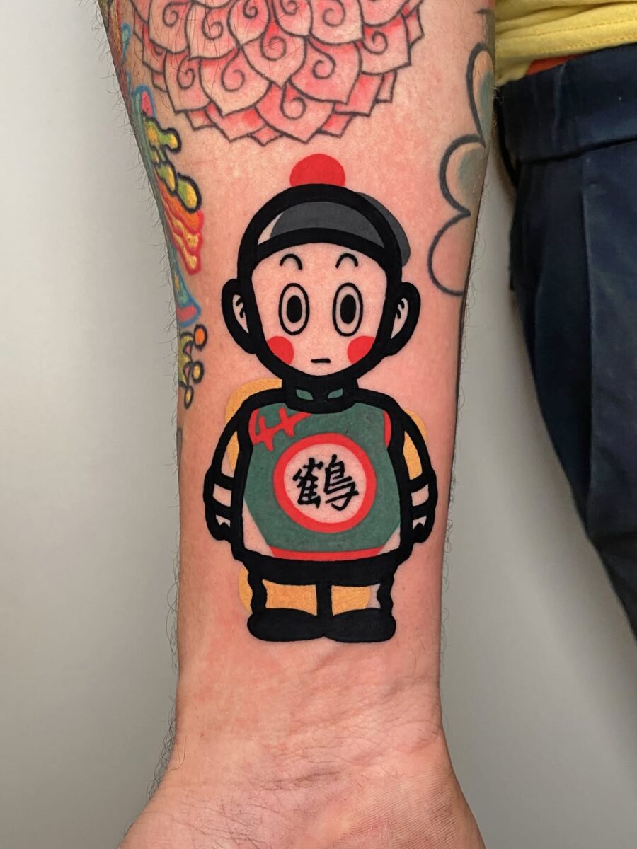 Playful cartoon design with vibrant colors Tattoo on skin