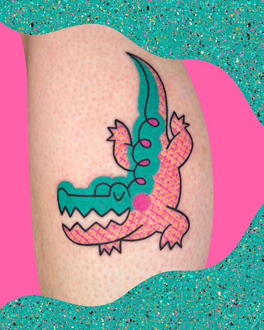 Playful crocodile tattoo bursting with color Tattoo on skin