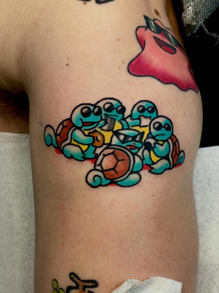 Playful Squirtles in Vibrant Ink Design Tattoo on skin