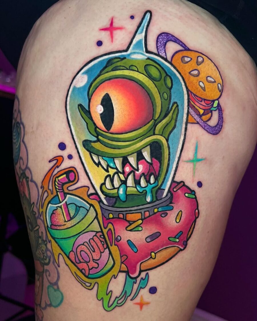 Vibrant alien tattoo with playful elements Tattoo on skin