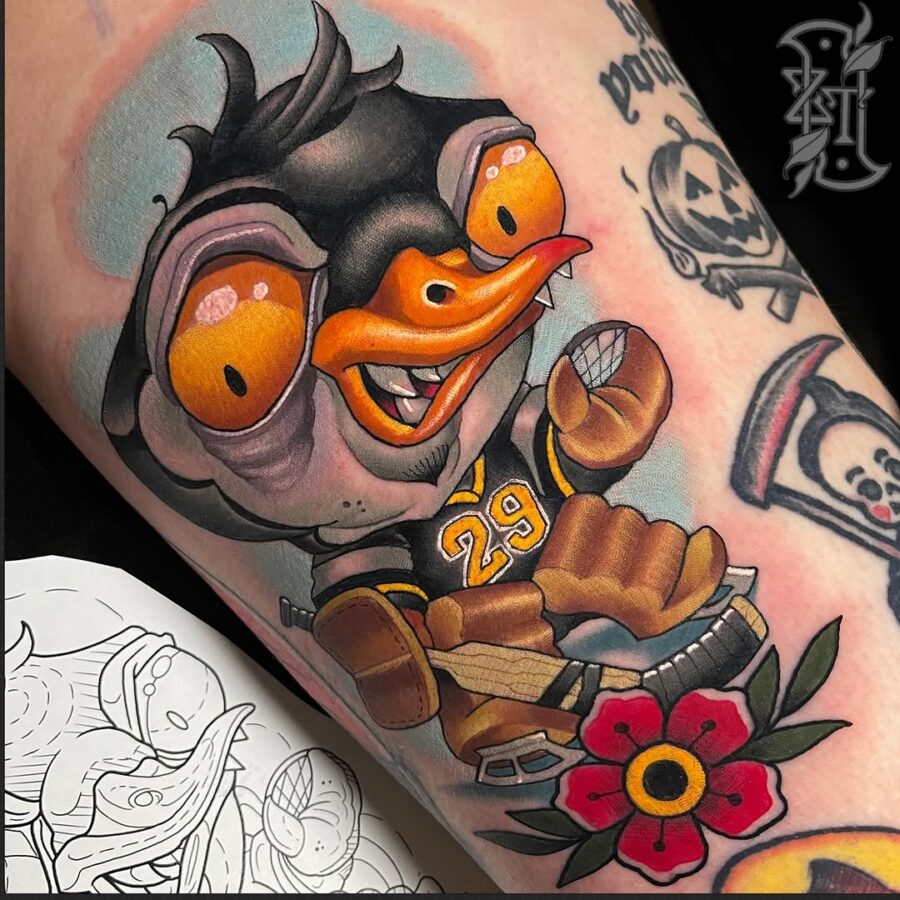 Vibrant cartoon tattoo with playful duck character Tattoo on skin