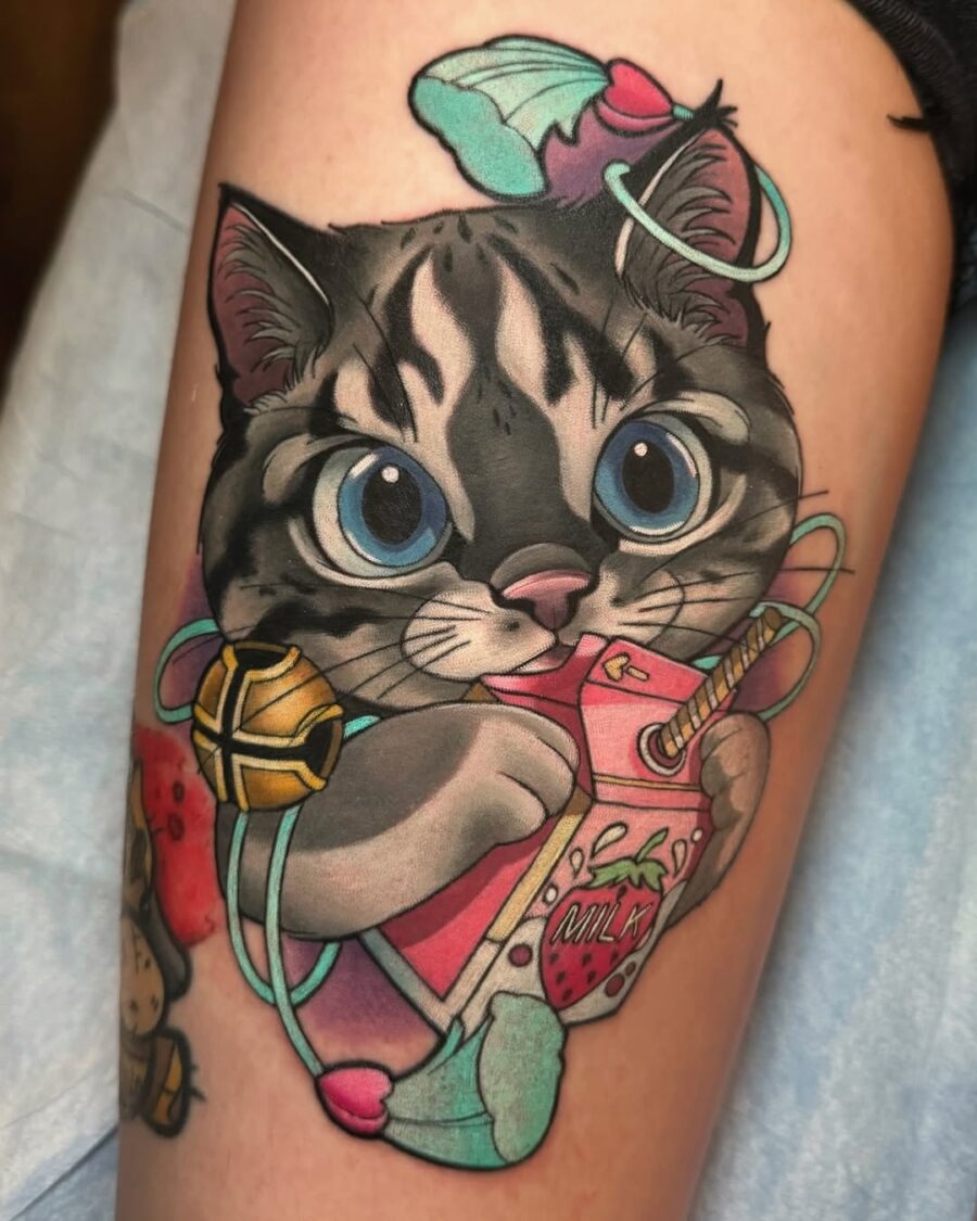 Whimsical cartoon cat tattoo with vibrant colors Tattoo on skin