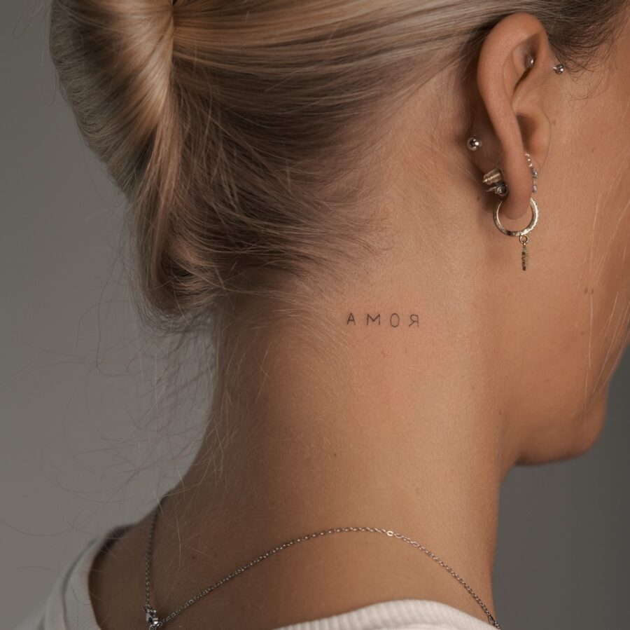 Elegant neck tattoo showcasing the word 'Amor' Tattoo on skin