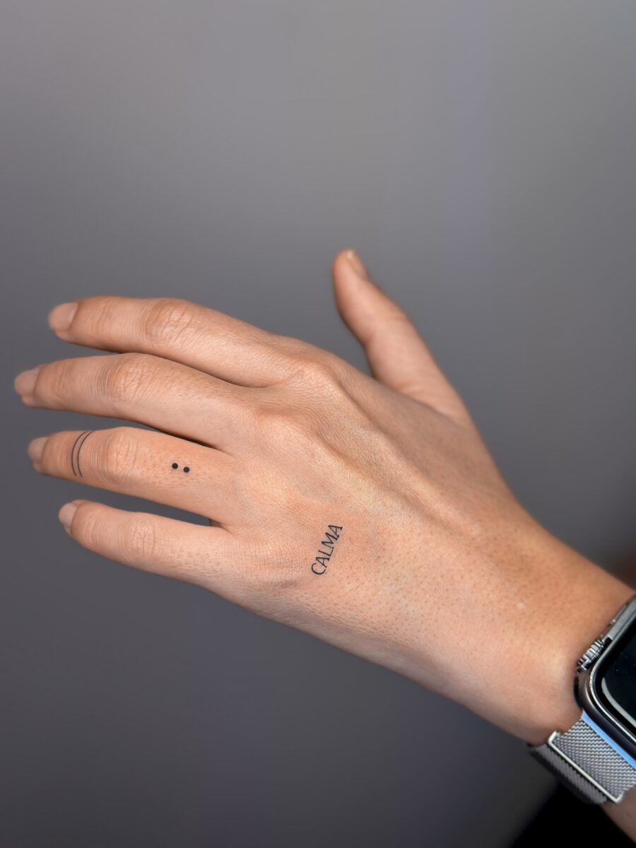 Minimalistic tattoo of the word 'Calma' Tattoo on skin