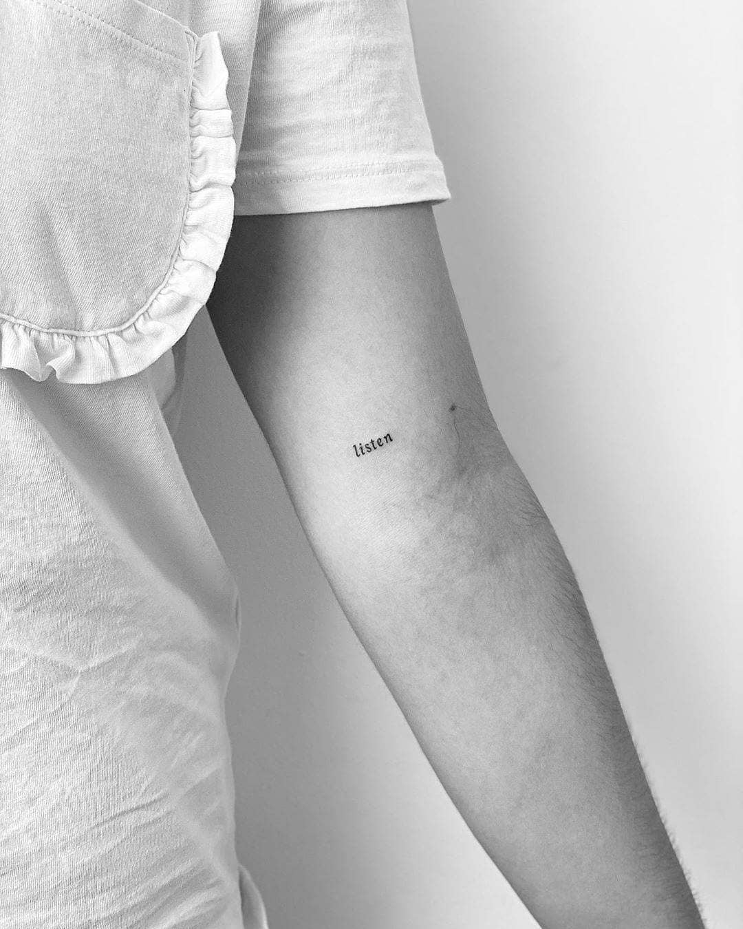 Expressive one-word tattoo: Listen Tattoo on skin
