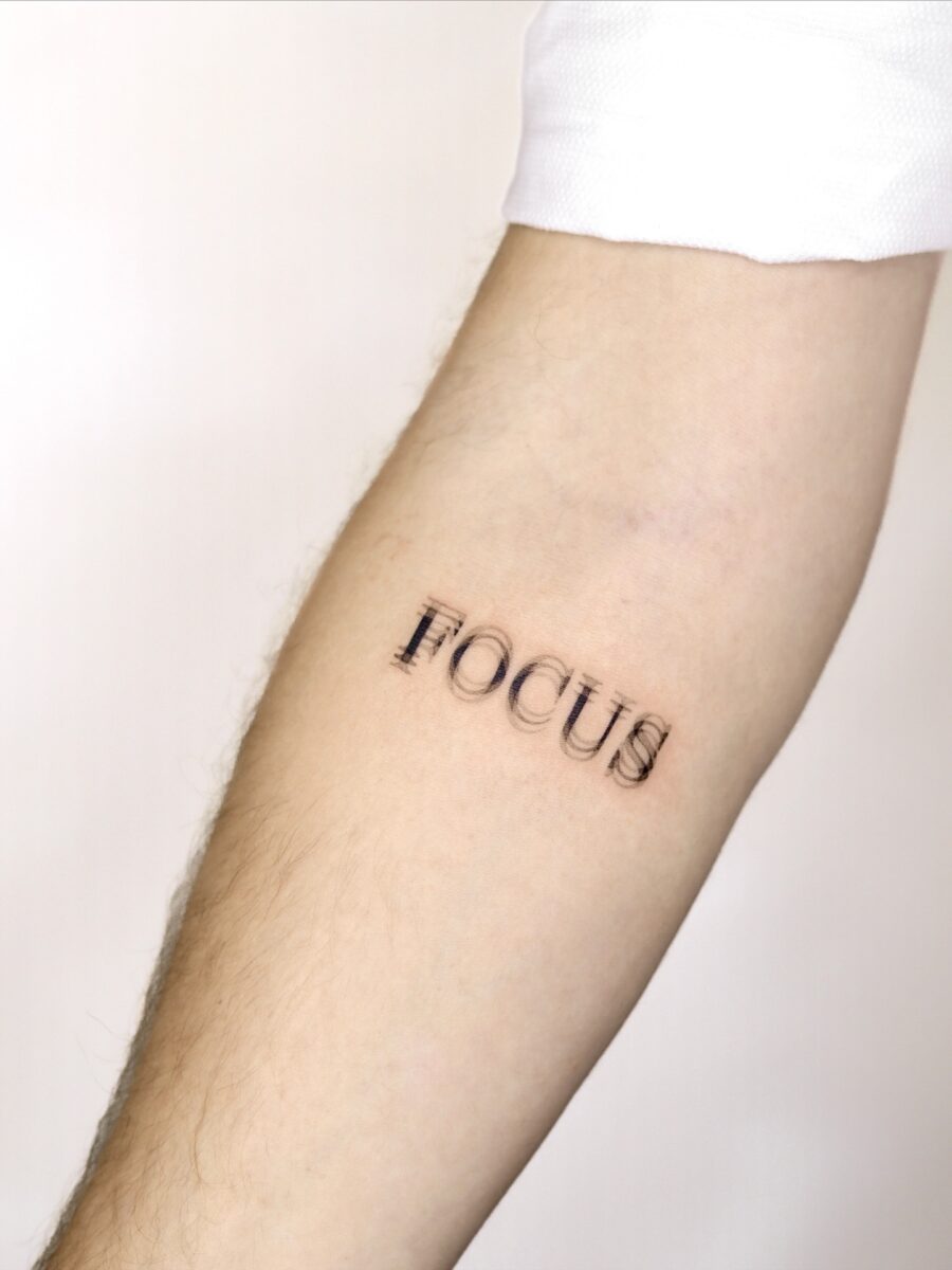 Minimalistic tattoo showcasing the word 'Focus' Tattoo on skin