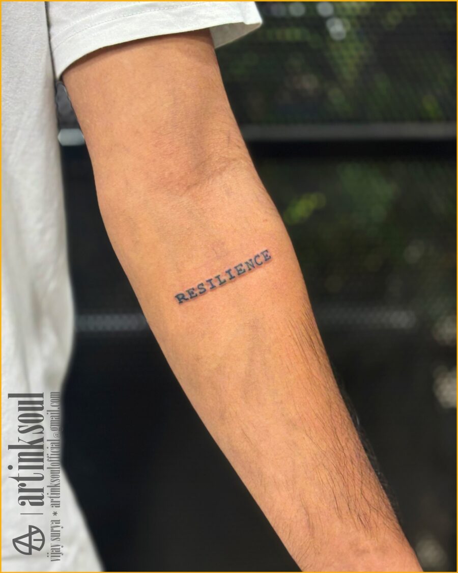 Symbolic one-word tattoo: Resilience on display Tattoo on skin