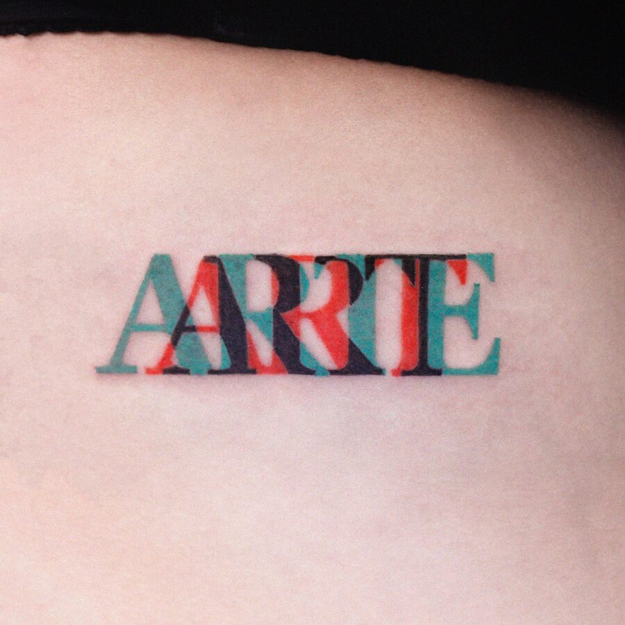 Vibrant one-word tattoo showcasing creativity Tattoo on skin