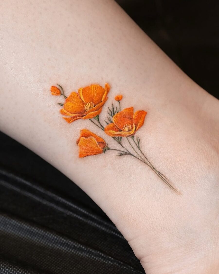 Charming orange floral tattoo on the ankle Tattoo on skin