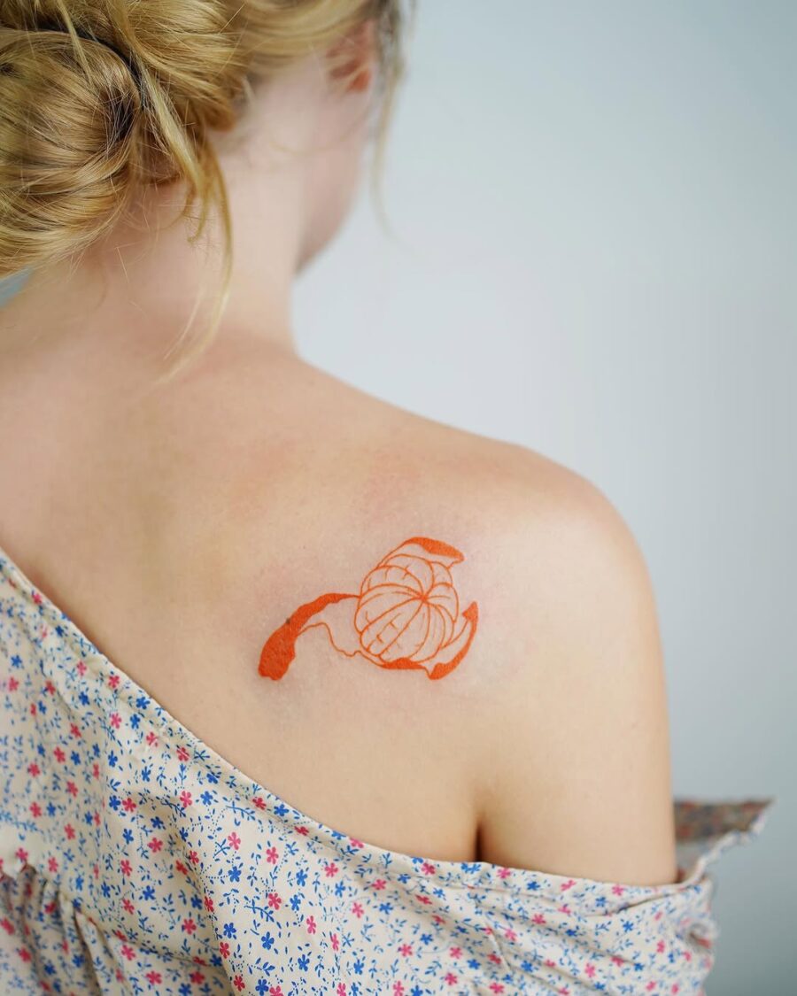 Delicate orange floral tattoo on shoulder Tattoo on skin