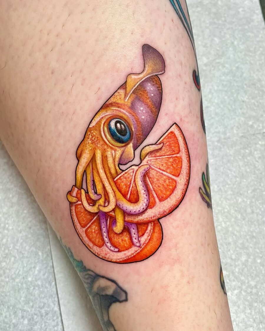 Playful squid with vibrant orange slices Tattoo on skin