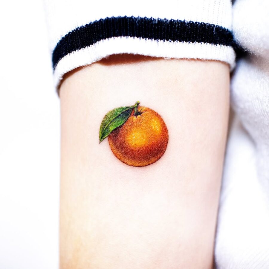 Realistic orange tattoo with vibrant details Tattoo on skin